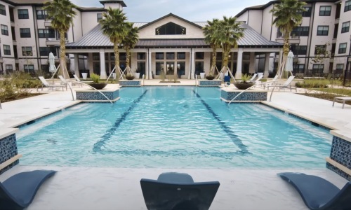 Resort-style swimming pool with lounge seating