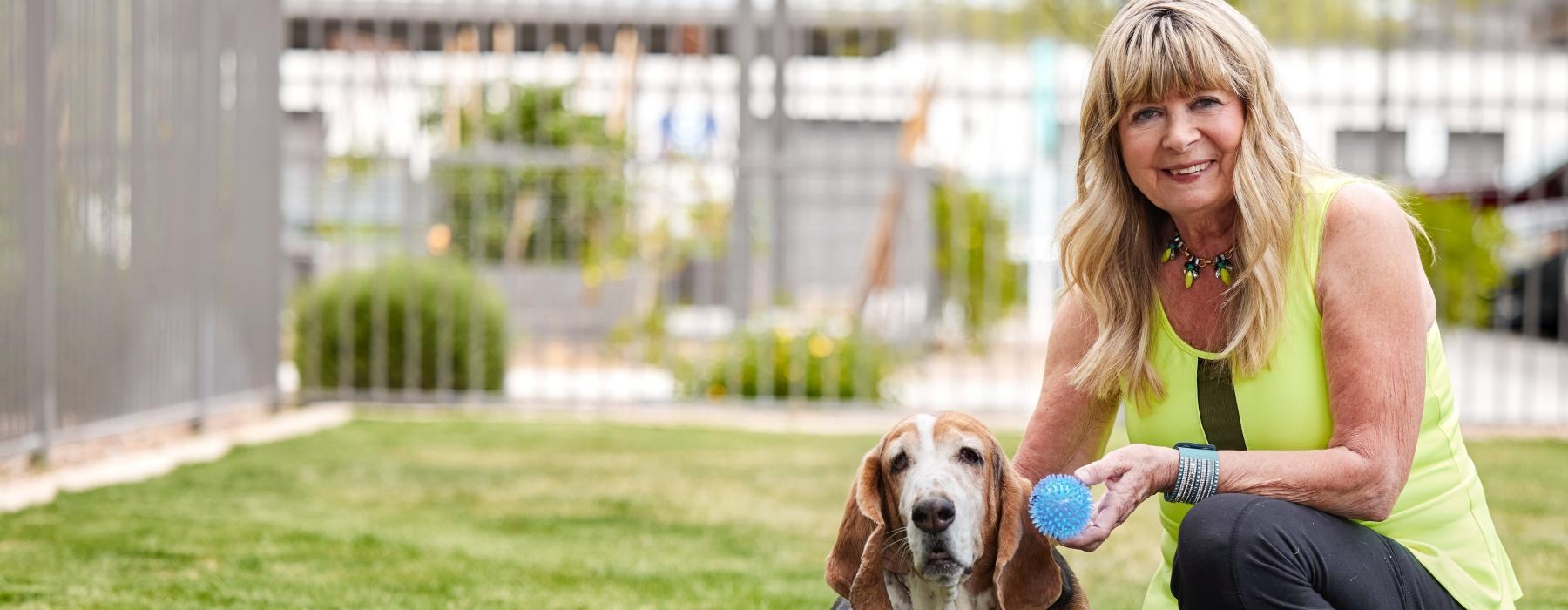a woman sitting with a dog